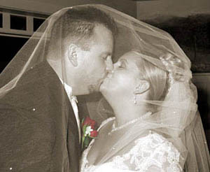 New Hampshire wedding photographers, Acclaim Professional Photography, photojournalist, bride and groom candid kissing.